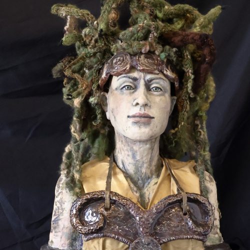 A ceramic bust of a person with green, snake-like hair, wearing a yellow top and ornate chest armor, is set against a dark background—perfect for adding a touch of mythical intrigue to any e-commerce collection.